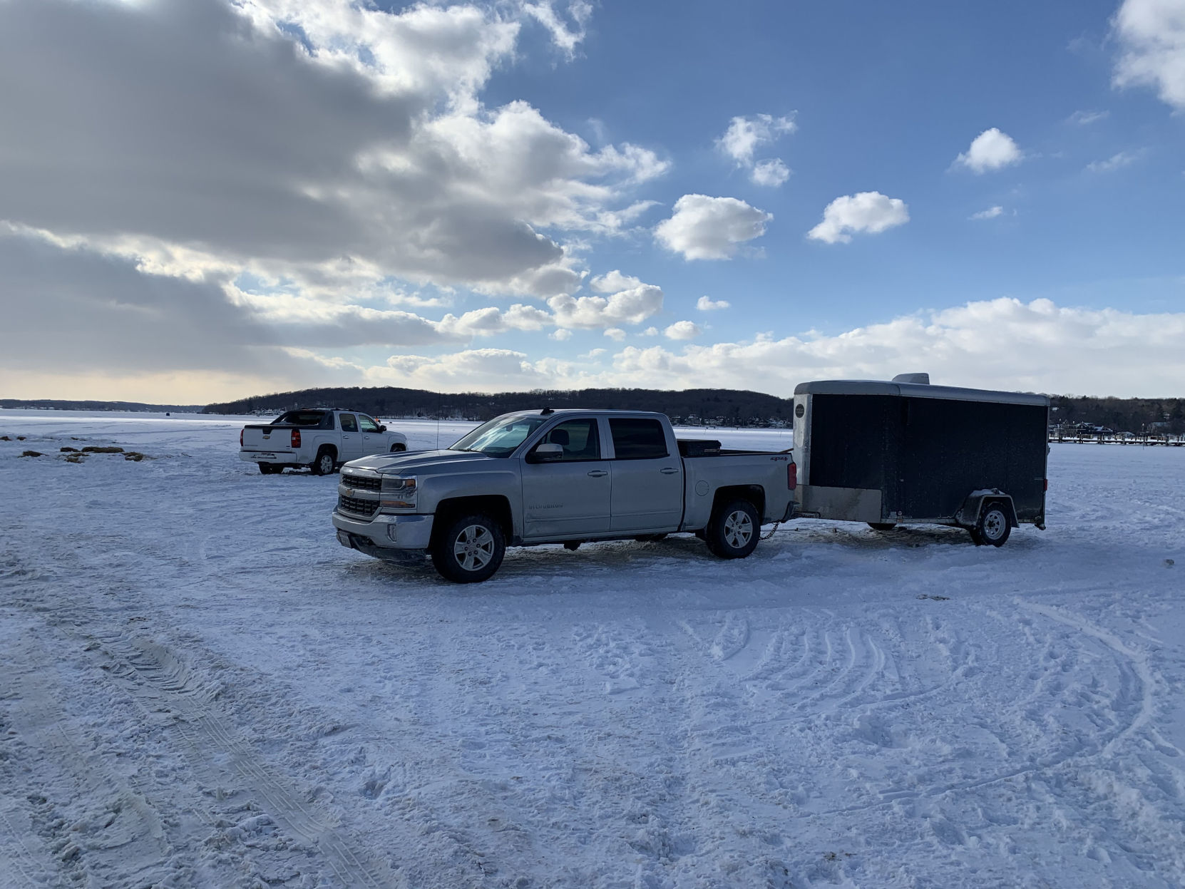 A vehicle with a trailer parked on Geneva Lake